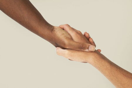 Helping hands holding charity gesture